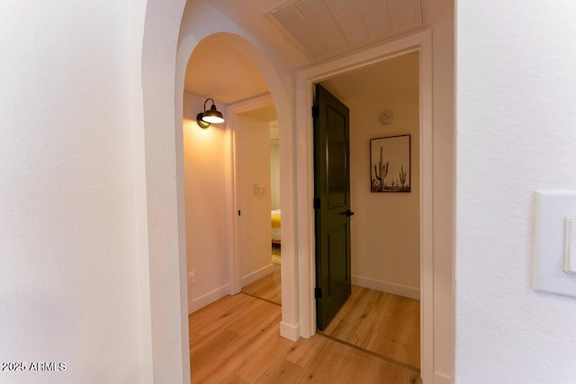 hallway with light hardwood / wood-style floors