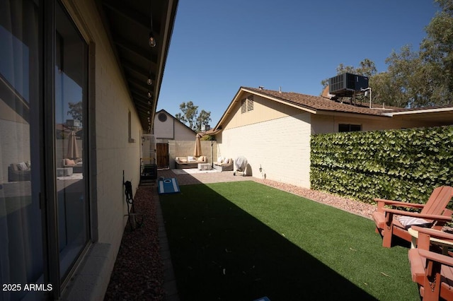 view of yard featuring a patio and central AC