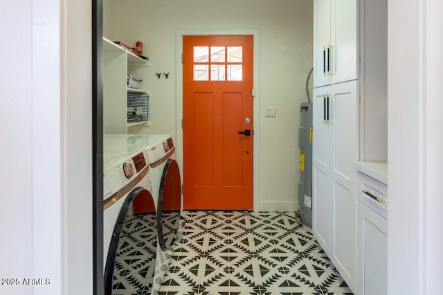 washroom featuring washer and dryer, cabinets, and water heater