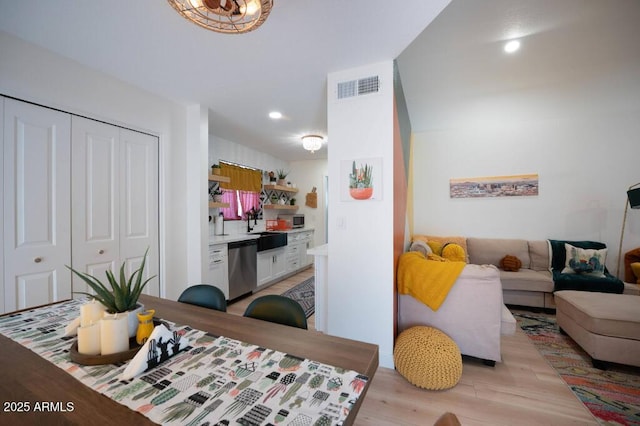 living room with sink and light hardwood / wood-style flooring