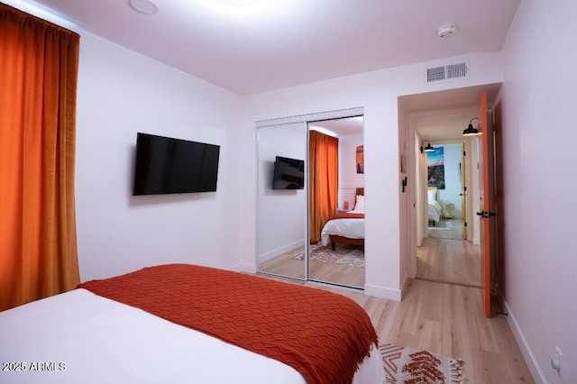 bedroom featuring light hardwood / wood-style floors and a closet