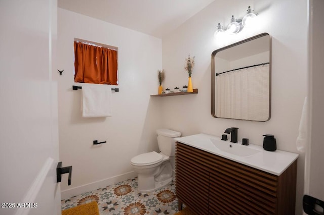 bathroom featuring tile patterned floors, toilet, and vanity