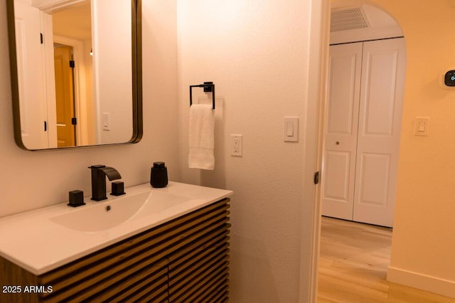 bathroom featuring vanity and hardwood / wood-style floors