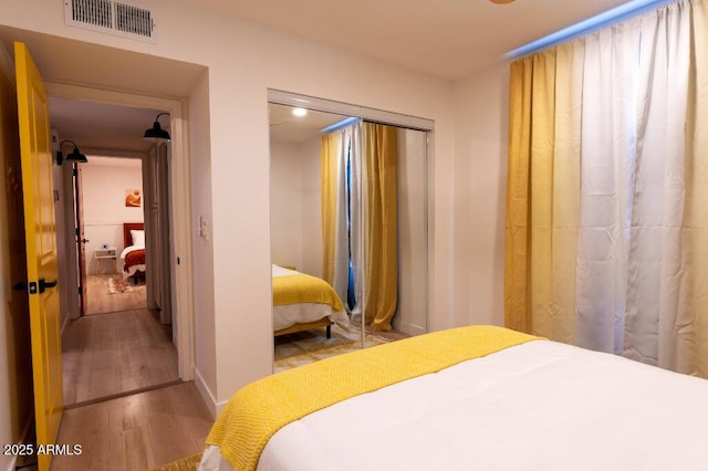 bedroom featuring light hardwood / wood-style floors and a closet