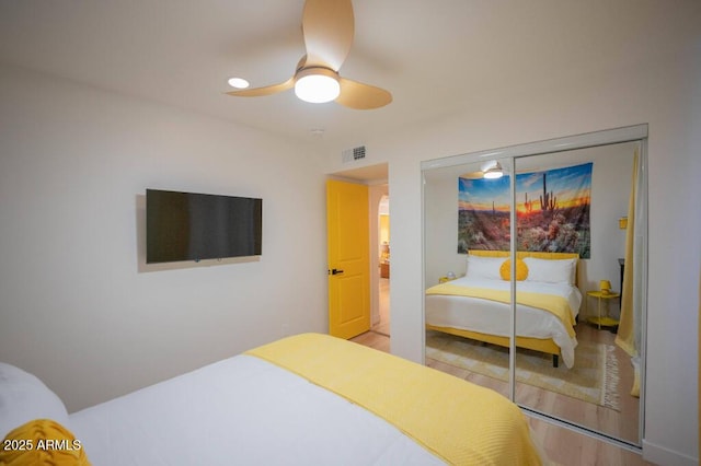 bedroom with ceiling fan and a closet