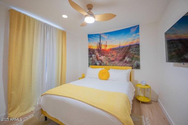 bedroom with ceiling fan and hardwood / wood-style flooring