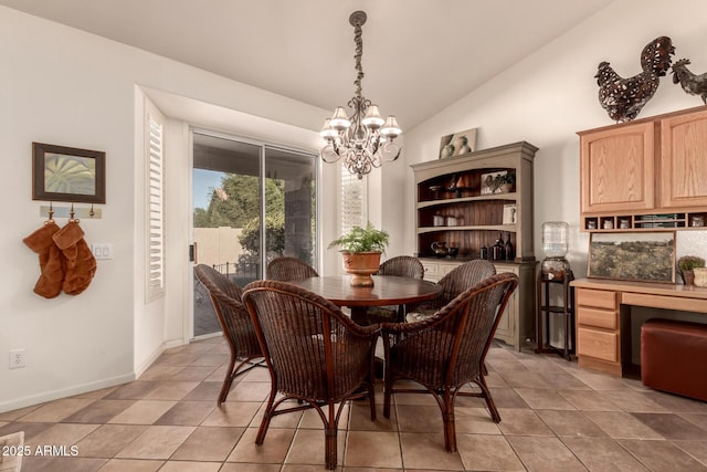 tiled dining space featuring lofted ceiling and an inviting chandelier