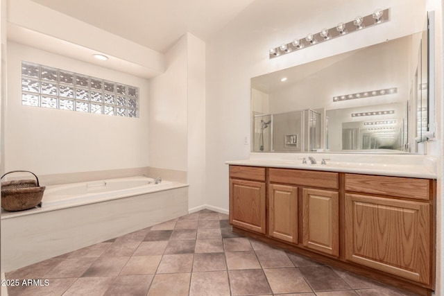 bathroom featuring tile patterned flooring, vanity, a healthy amount of sunlight, and shower with separate bathtub