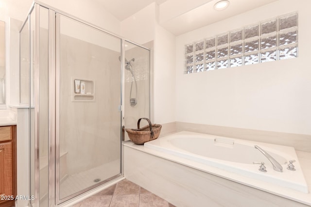 bathroom featuring tile patterned flooring, vanity, and shower with separate bathtub