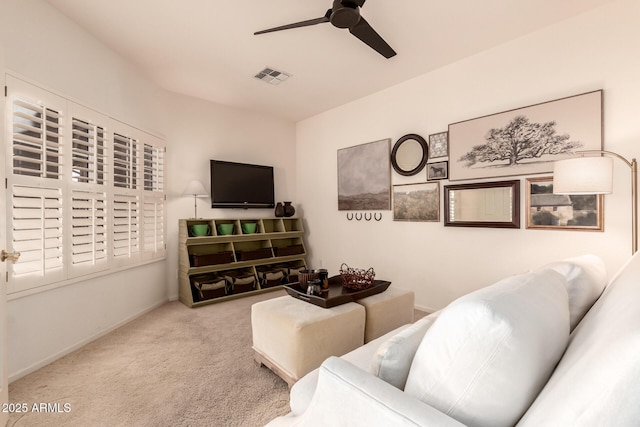 carpeted living room featuring ceiling fan