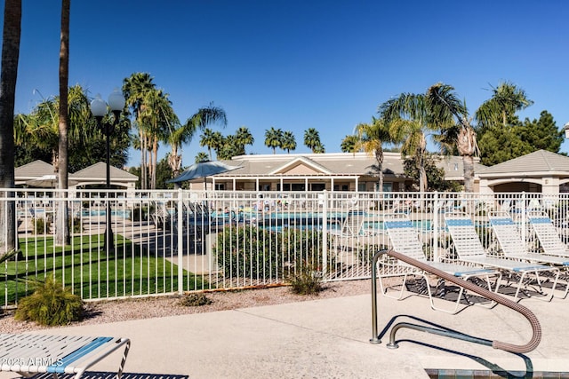 view of pool featuring a lawn