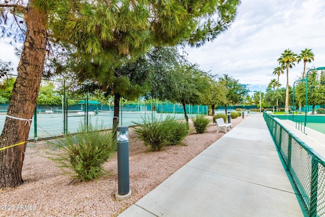 view of property's community featuring tennis court