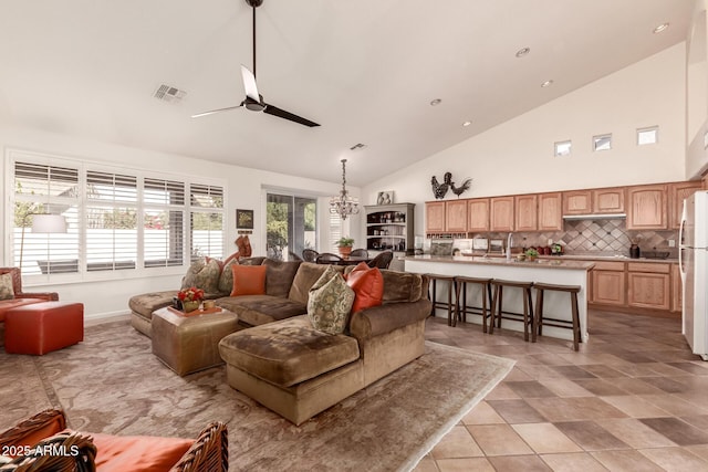 living room with high vaulted ceiling and ceiling fan