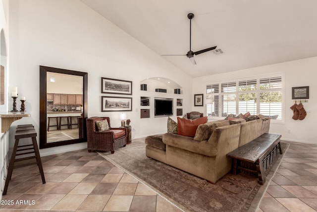 living room with ceiling fan, light tile patterned flooring, and high vaulted ceiling