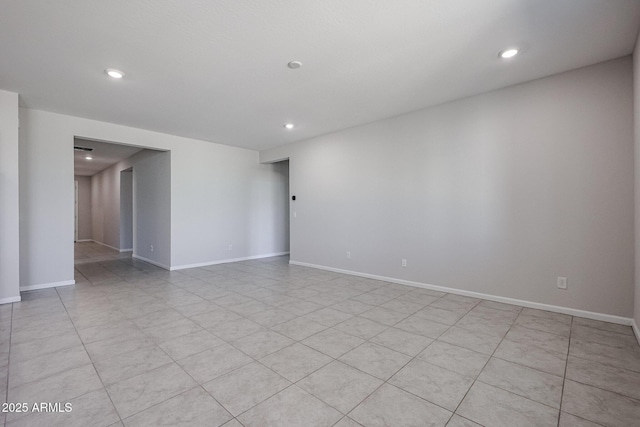 empty room with baseboards and recessed lighting