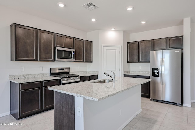 kitchen featuring a sink, visible vents, appliances with stainless steel finishes, and dark brown cabinetry