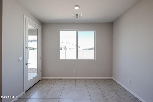 unfurnished room featuring visible vents and baseboards