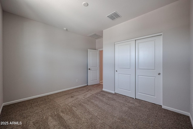 unfurnished bedroom with visible vents, baseboards, a closet, and carpet floors