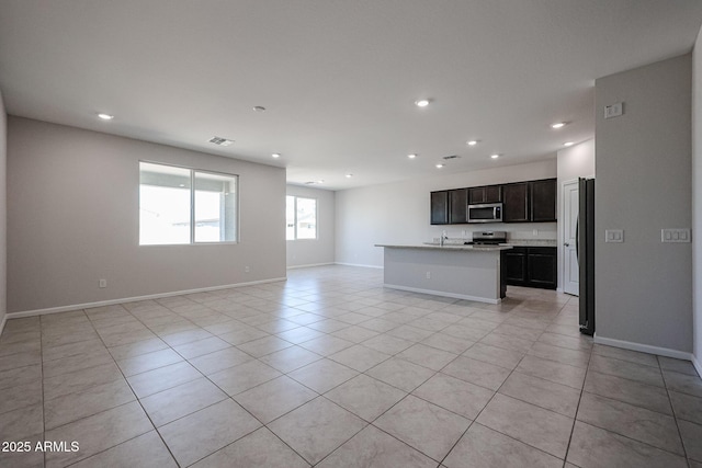 unfurnished living room featuring light tile patterned floors, baseboards, recessed lighting, and visible vents