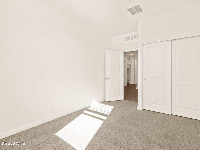 unfurnished bedroom with carpet floors and a closet