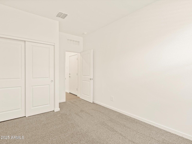 unfurnished bedroom featuring carpet flooring and a closet