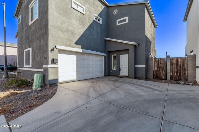 view of front of property featuring concrete driveway and stucco siding