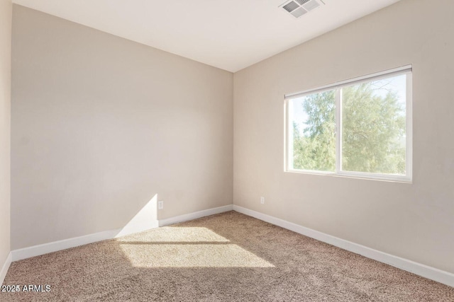 carpeted spare room with baseboards and visible vents