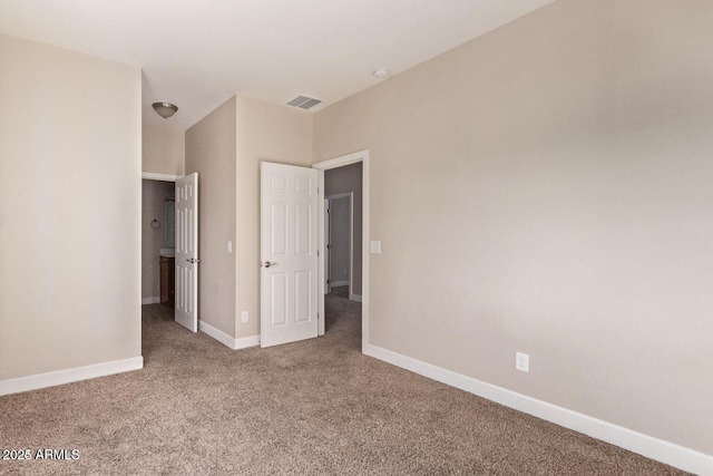 unfurnished bedroom featuring carpet flooring, visible vents, and baseboards