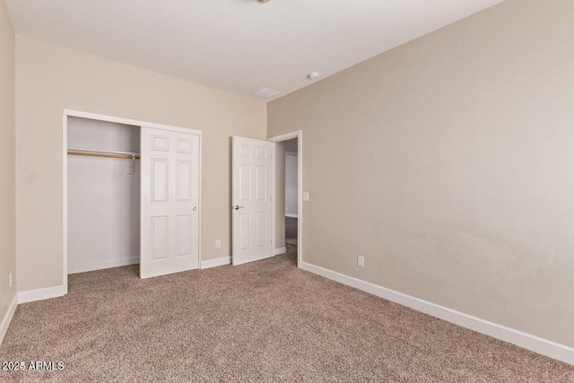 unfurnished bedroom featuring carpet, baseboards, and a closet