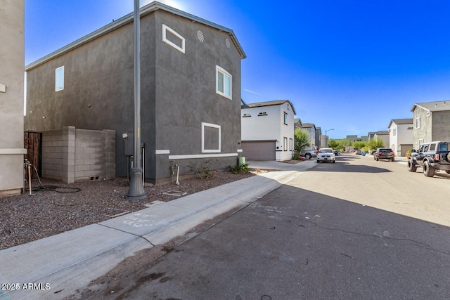 exterior space with a residential view and stucco siding