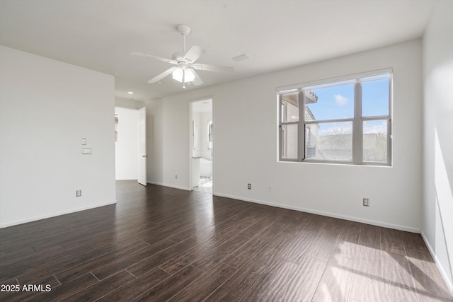 empty room featuring a ceiling fan, baseboards, and dark wood finished floors