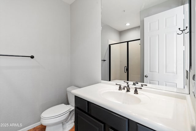 full bath featuring vanity, a stall shower, and toilet