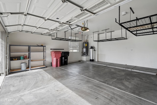 garage featuring a garage door opener and water heater