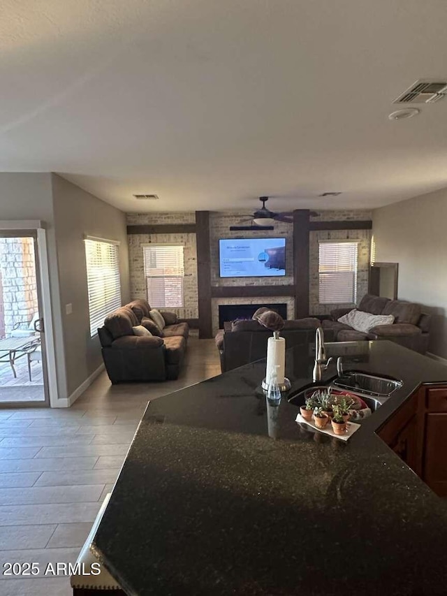 28306 N 25th Dl, Phoenix, AZ 85085 - living room featuring a ceiling fan and a fireplace