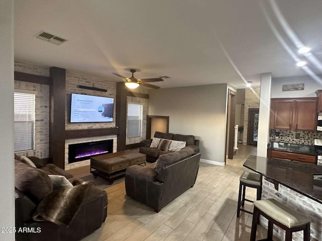 28306 N 25th Dl, Phoenix, AZ 85085 - living area featuring light wood-type flooring, a fireplace, and a ceiling fan