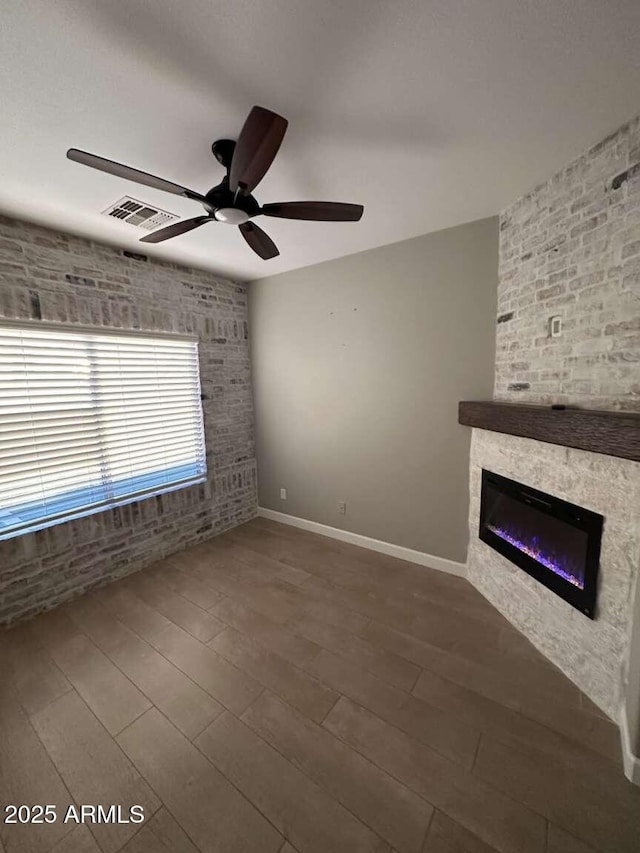 28306 N 25th Dl, Phoenix, AZ 85085 - unfurnished living room featuring a ceiling fan, a fireplace, and wood finished floors