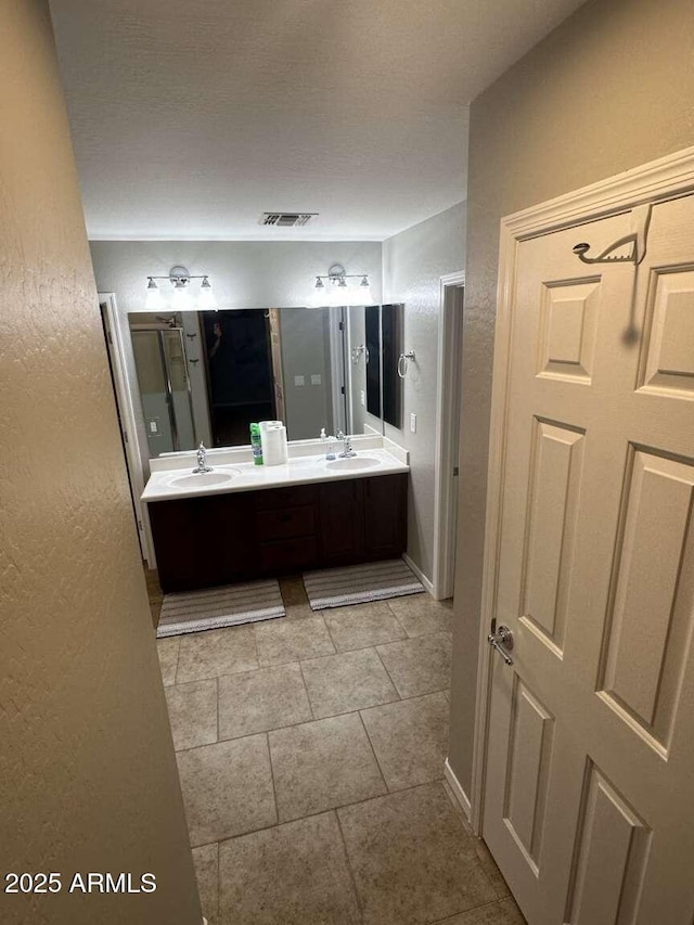 28306 N 25th Dl, Phoenix, AZ 85085 - bathroom featuring double vanity, tile patterned floors, and a textured wall