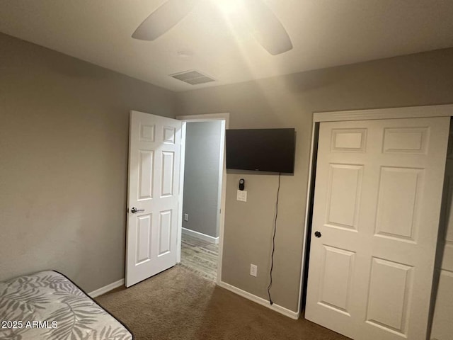 28306 N 25th Dl, Phoenix, AZ 85085 - unfurnished bedroom with dark colored carpet, a closet, and a ceiling fan