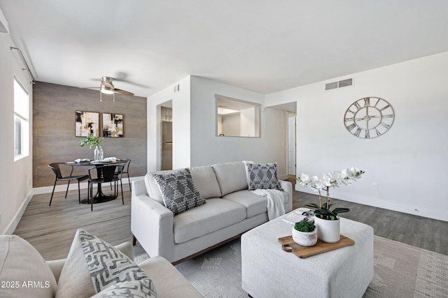 616 S Hardy Dr Unit 203, Tempe, AZ 85281 - living room featuring an accent wall, wood finished floors, and ceiling fan