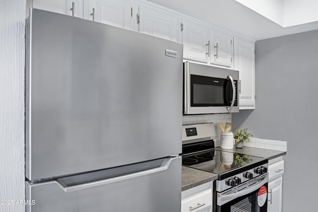 616 S Hardy Dr Unit 203, Tempe, AZ 85281 - kitchen featuring appliances with stainless steel finishes, backsplash, white cabinetry, and dark countertops