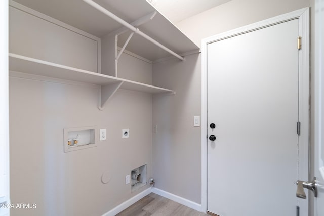 laundry area featuring hookup for an electric dryer, gas dryer hookup, light wood-type flooring, and hookup for a washing machine