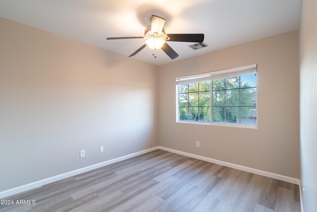 spare room featuring ceiling fan and light hardwood / wood-style flooring