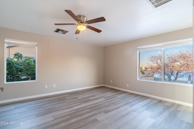 spare room with ceiling fan and light hardwood / wood-style floors