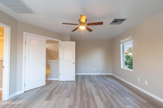 unfurnished bedroom with a closet, light hardwood / wood-style flooring, and ceiling fan