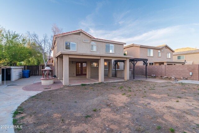 rear view of house featuring french doors and a patio area