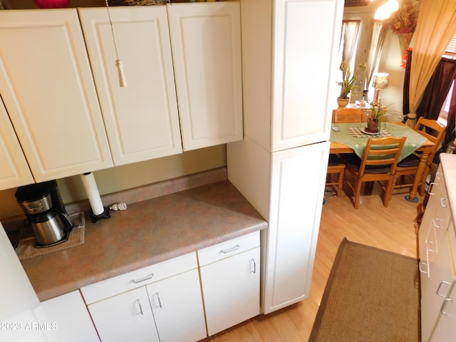 kitchen with white cabinets and light wood-style flooring