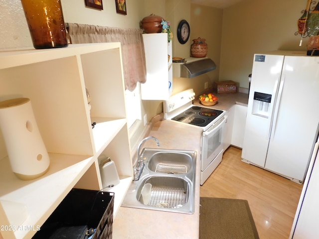 kitchen with light wood-type flooring, a sink, ventilation hood, white appliances, and white cabinets