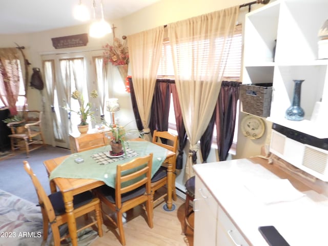 dining area featuring light wood-style floors and a wealth of natural light