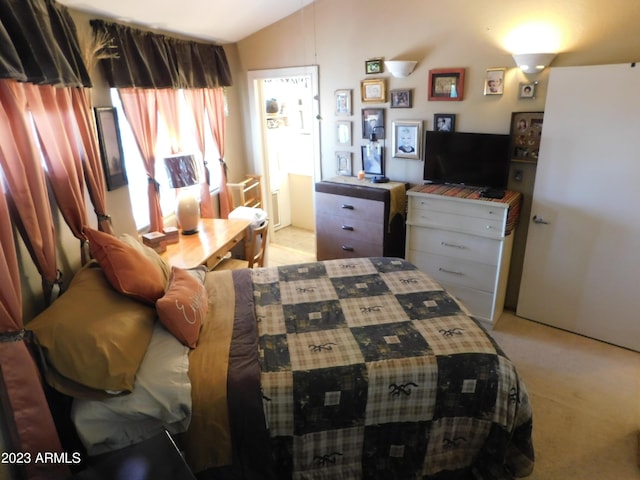 bedroom with light carpet and lofted ceiling