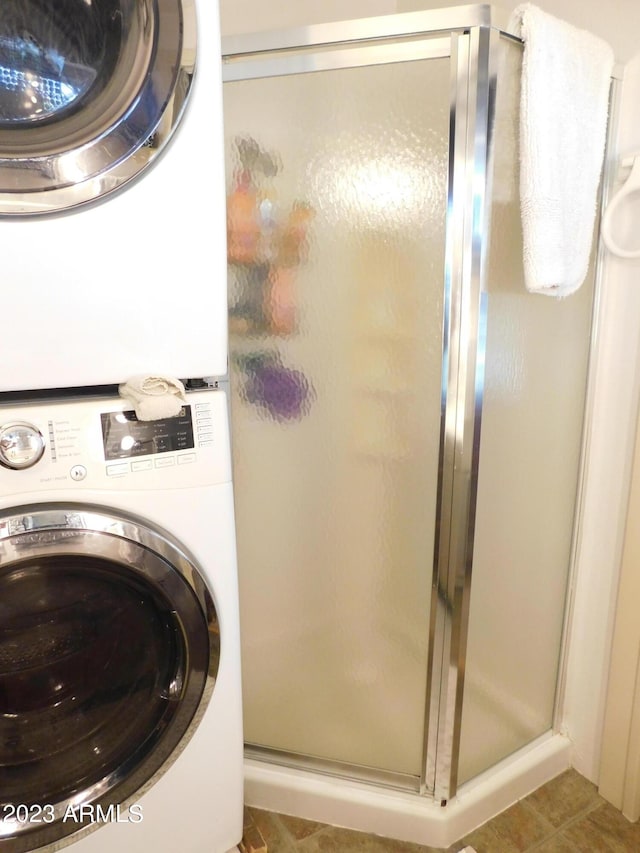 laundry area featuring laundry area and stacked washer and clothes dryer